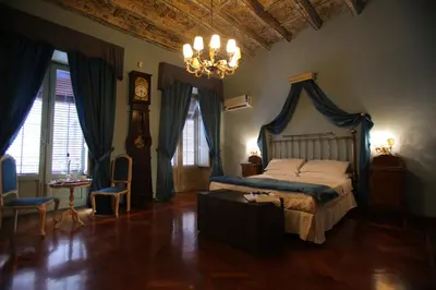 a bedroom with a bed and a chandelier at Antica Palermo R&B in Palermo