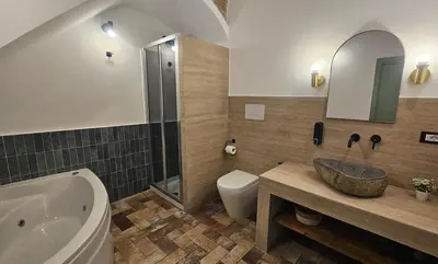 a bathroom with a tub and a sink and a toilet at Barbarò Apartments in Palermo