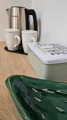 a counter with a coffee pot and cups on a table at Barbarò Apartments in Palermo