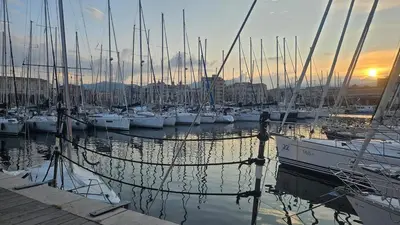 a group of boats docked in a marina at sunset at Barbarò Apartments in Palermo