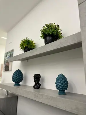 a shelf with three pots of plants on it at Vitale House in Borgetto
