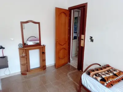 a room with a mirror and a dresser and a bed at City-Inn II with 2 comfortable single beds in Palermo
