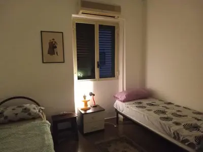 a bedroom with a bed and a window at City-Inn II with 2 comfortable single beds in Palermo