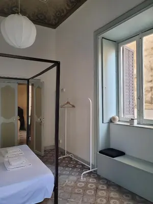 a bedroom with a bed and a large mirror at MojoCoHouse in Palermo