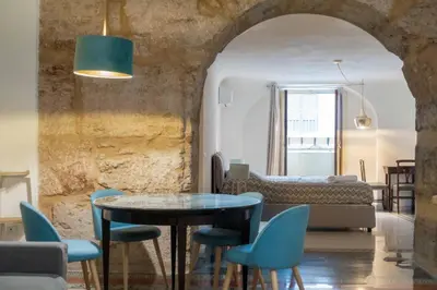 a living room with a table and chairs at MojoCoHouse in Palermo