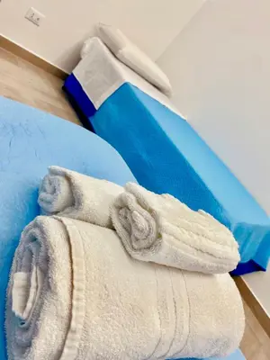 a pile of towels sitting on top of a table at Santerasmo Rooms king in Palermo