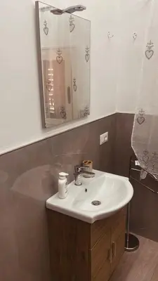 a bathroom with a sink and a mirror at Santerasmo Rooms king in Palermo