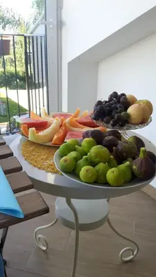 a tray of fruits and vegetables on a table at B&B Menta & Peperoncino in Partinico