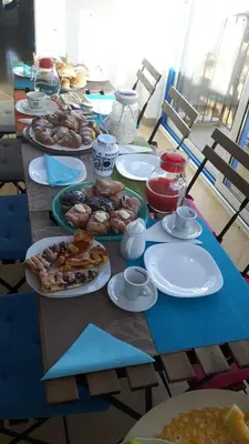 a long table with plates of food on it at B&B Menta & Peperoncino in Partinico