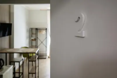 a door in a room with a table and chairs at Oros rooms in Palermo