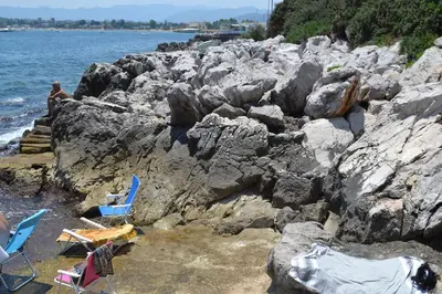 a group of chairs sitting on a rocky beach at La Dimora di Alice in Palermo