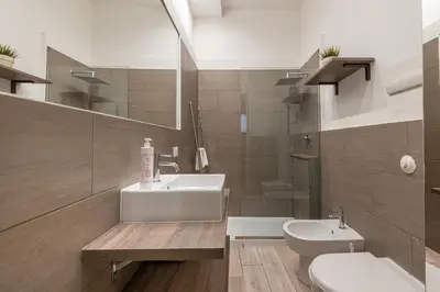 a bathroom with a sink and a toilet at Real Umberto Apartments by Wonderful Italy in Palermo