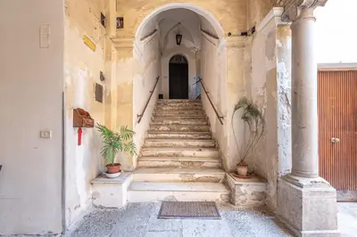 a stairway leading up to a building with a door at Real Umberto Apartments by Wonderful Italy in Palermo