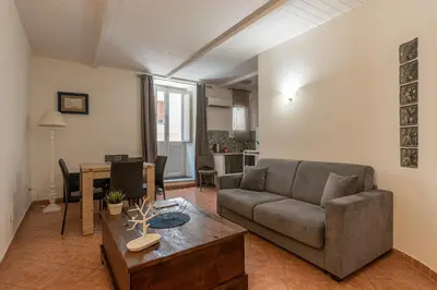 a living room with a couch and a table at Real Umberto Apartments by Wonderful Italy in Palermo