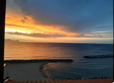 a sunset over the ocean with a beach at Villa Adele in Trappeto