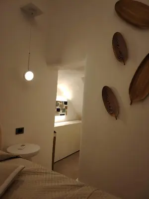 a bedroom with a bed and wooden plates on the wall at Cappuccetto Rosso Sweet Modern Suite Palermo in Palermo