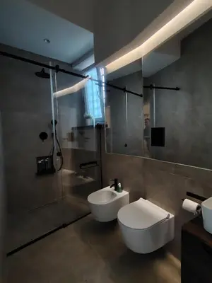 a bathroom with a sink and a toilet and a shower at Cappuccetto Rosso Sweet Modern Suite Palermo in Palermo