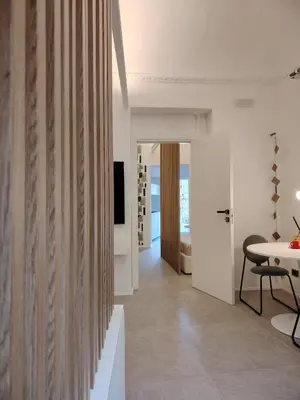 a hallway with a table and a dining room at Cappuccetto Rosso Sweet Modern Suite Palermo in Palermo