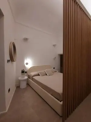 a bedroom with a large bed and a bathroom at Cappuccetto Rosso Sweet Modern Suite Palermo in Palermo