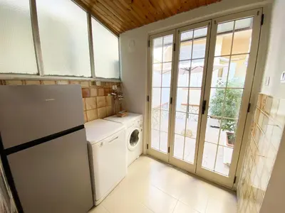 a kitchen with a refrigerator and a washer and dryer at Il Vialetto in Mondello