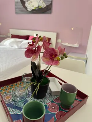 a tray with flowers on a table in a bedroom at Dimora 51 in Palermo
