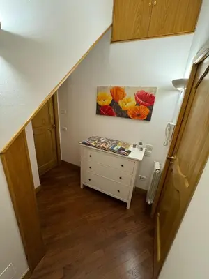 an attic room with a dresser and a painting on the wall at Dimora 51 in Palermo