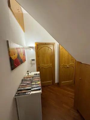 a room with a hallway with a door and a shelf with books at Dimora 51 in Palermo