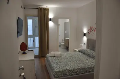 a bedroom with two beds and a bathroom at Casa Giovannella in Palermo