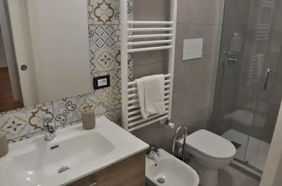 a bathroom with a sink and a toilet at Casa Giovannella in Palermo
