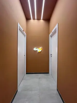 an empty corridor with two doors and a sign on the wall at kumpa' sicilian apartments in Palermo