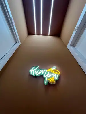 a neon sign in the corner of a room at kumpa' sicilian apartments in Palermo