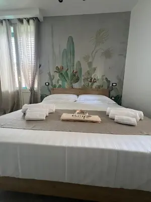 a bedroom with two beds with towels on them at kumpa' sicilian apartments in Palermo