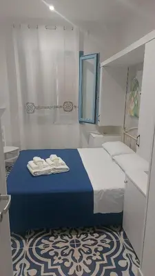 a bedroom with a bed with towels on it at Benvenuti al Sud B&B in Macari