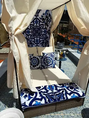 a bed in a tent with blue and white pillows at Opera Dolce in Carini