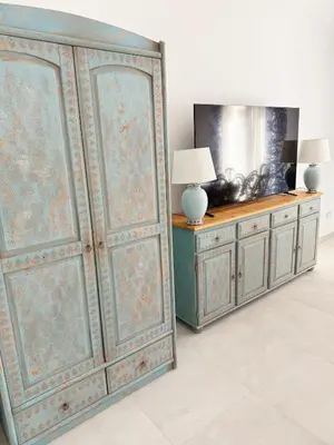 a large wooden cabinet in a room with a lamp at Opera Dolce in Carini