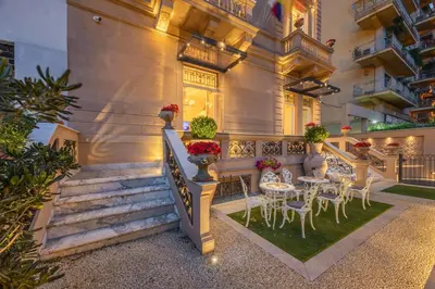 a house with a staircase and tables and chairs at Villa Libertà in Palermo