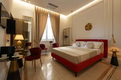 a bedroom with a red bed and a living room at Villa Libertà in Palermo