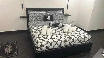 a black and white bed with teddy bears on it at black d'ossuna in Palermo