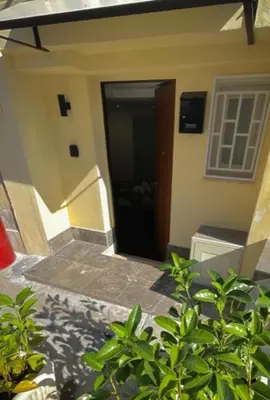 a door to a house with a stairway leading to it at black d'ossuna in Palermo