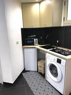 a kitchen with a washing machine and a microwave at black d'ossuna in Palermo