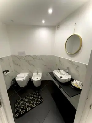 a bathroom with two toilets and a mirror at black d'ossuna in Palermo