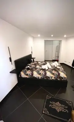 a bedroom with a bed with a dog on it at black d'ossuna in Palermo