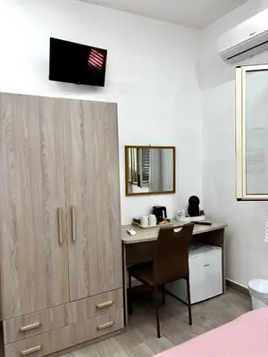 a bedroom with a desk and a mirror at Santerasmo Rooms standard in Palermo