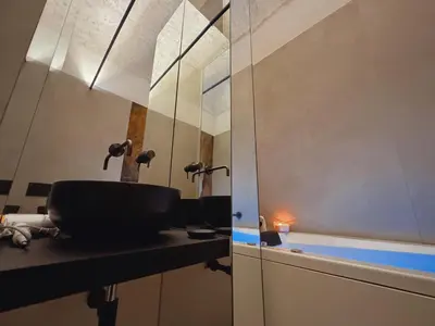 a bathroom with a sink and a tub at Corona Suite & Rooms in Palermo