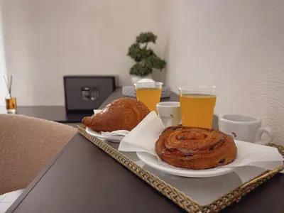 a tray with bread and two glasses of orange juice at Corona Suite & Rooms in Palermo