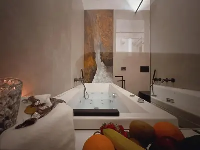 a bathroom with a bath tub with a sink at Corona Suite & Rooms in Palermo