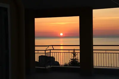 a view of a sunset from a balcony at A' Terrazza in Santa Flavia