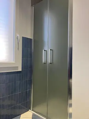 a shower with a glass door in a bathroom at A' Terrazza in Santa Flavia