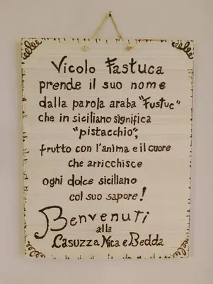 a sign that has some writing on it at Casuzza Nica e Bedda-Centro storico in Palermo