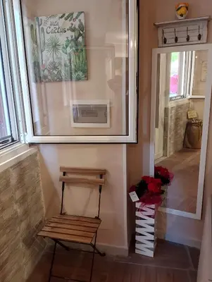 a bench in a room with a picture on the wall at Casuzza Nica e Bedda-Centro storico in Palermo